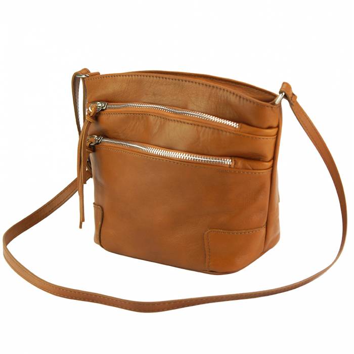 a brown purse sitting on a white surface 