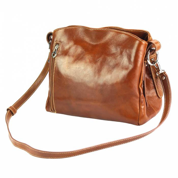 a brown purse sitting on a white surface 